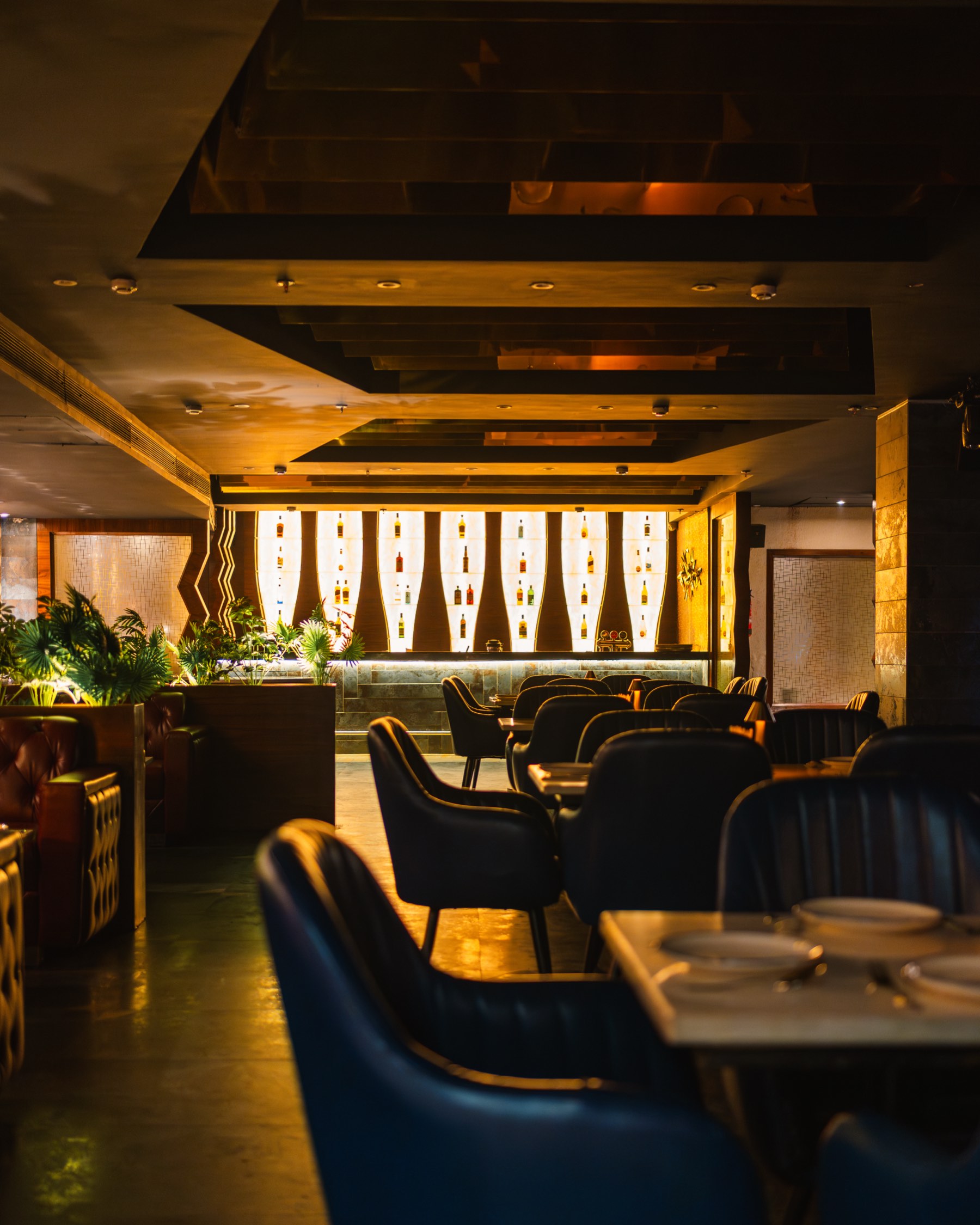 Bellers, the backlit bottle niches across the room and blue chairs at the tables