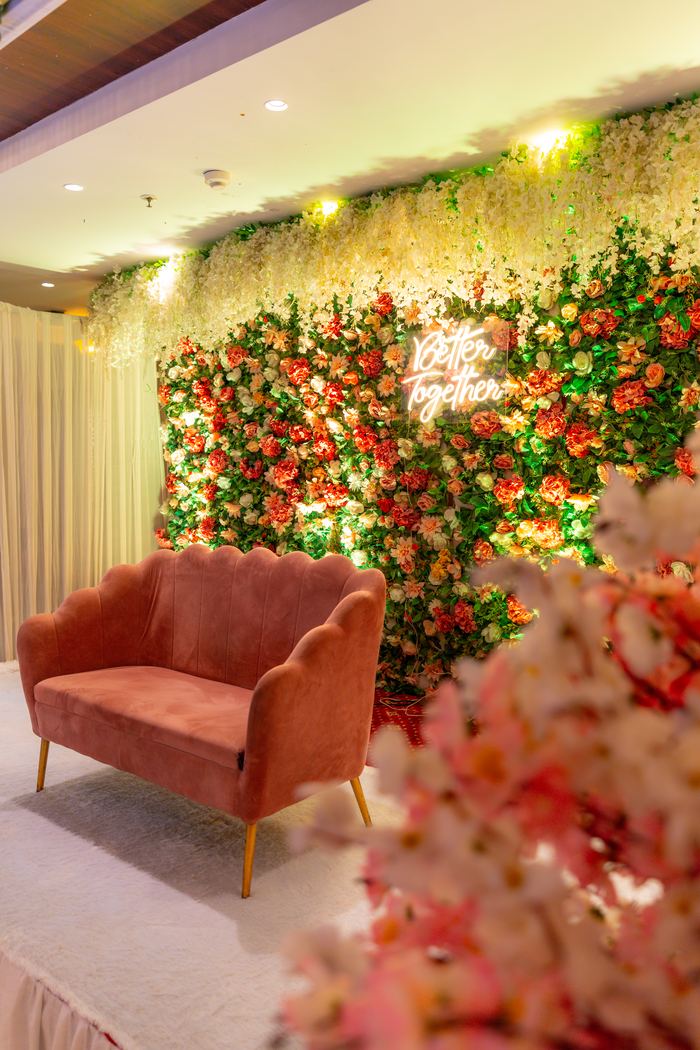 A seat set against the flower wall