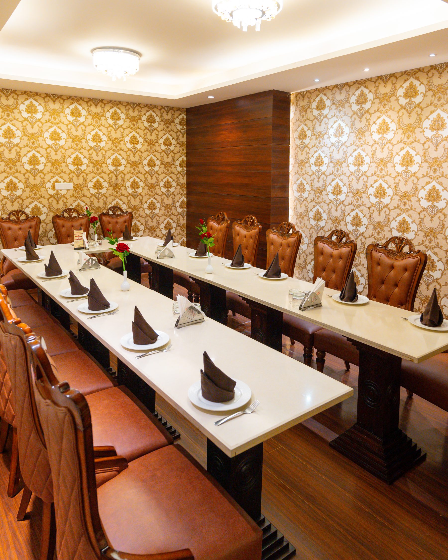 A private dining room, the long table laid for a party