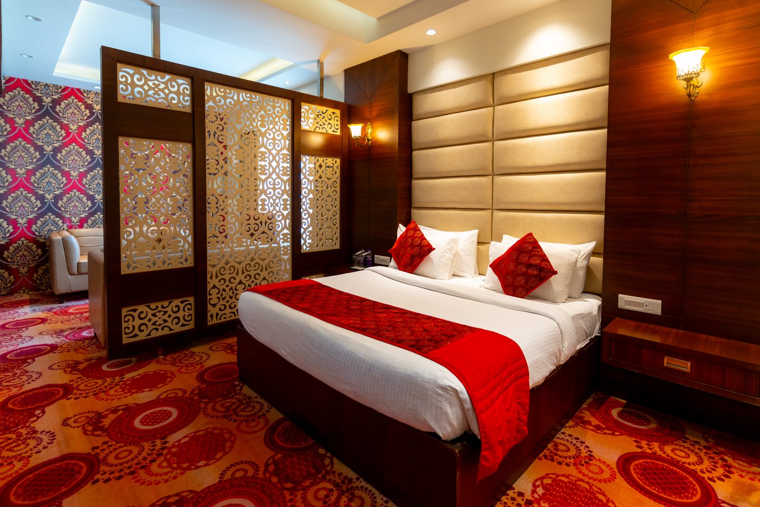 A Suite, the bed framed by the carved screen