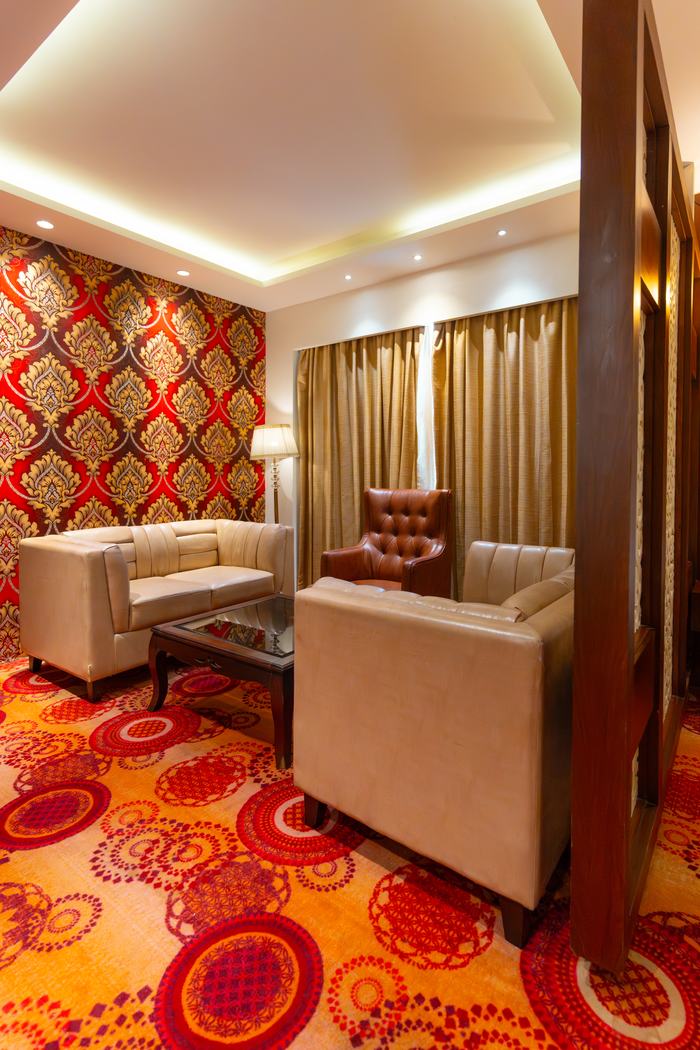 The Suite's own sitting room, sofas on the patterned carpet