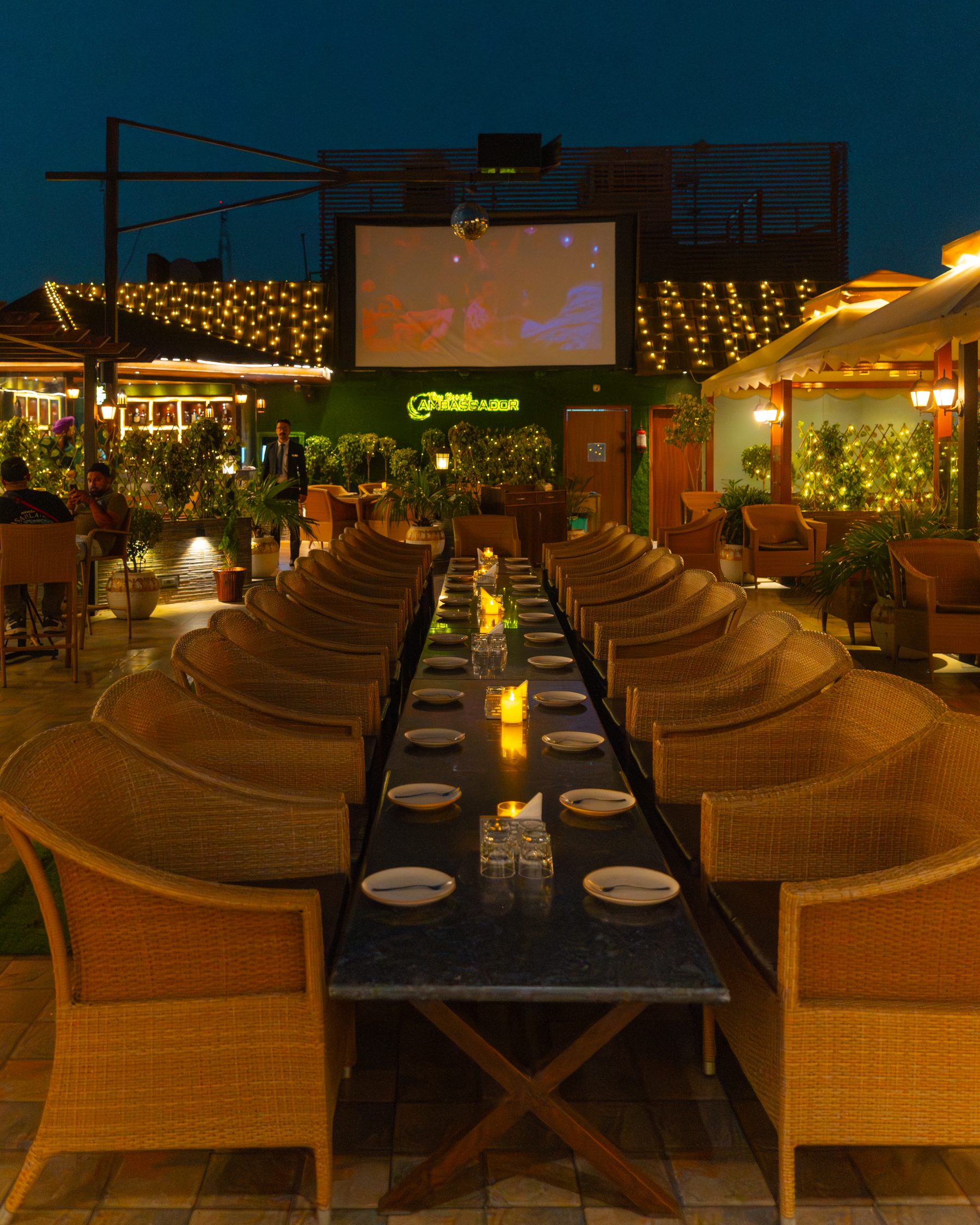 The terrace laid as one long table at night